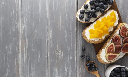 flat-lay-sandwiches-with-cream-cheese-fruits-with-copy-space